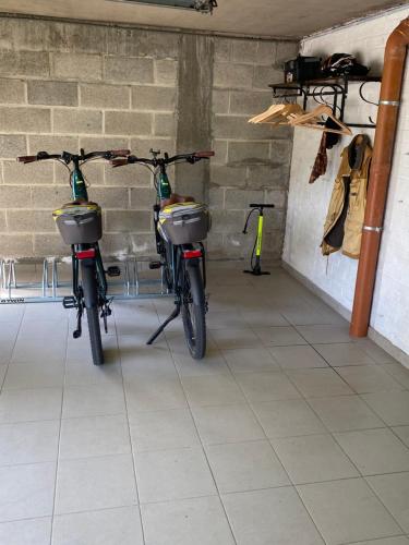 two bikes parked next to each other in a room at La colline aux hirondelles in La Roche-en-Ardenne