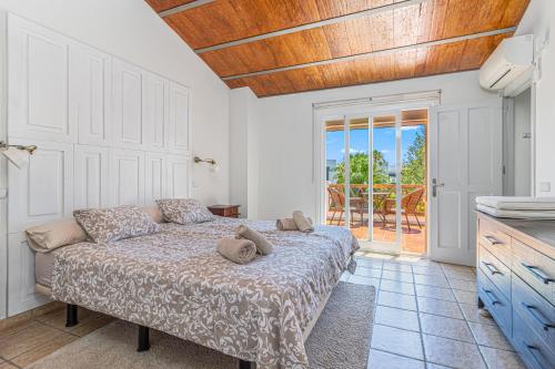a bedroom with a bed and a sliding glass door at Spacious Beachfront Town House in Estepona with Fully Equipped Kitchen, Pools, Garden, Sea View in Estepona