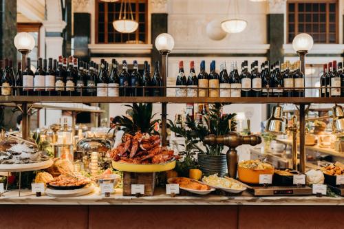 a buffet of food and bottles of wine at The Ned in London