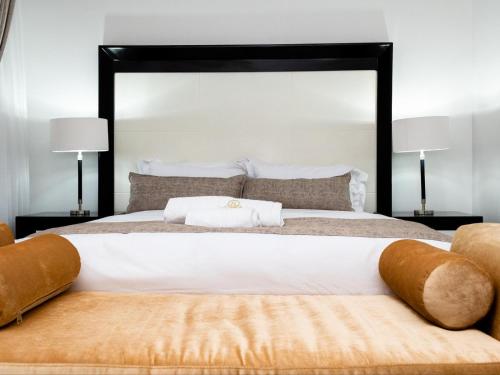 a bedroom with a large bed with a large headboard at Royal Lodge in Sibasa