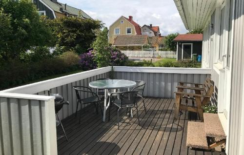a patio with a table and chairs on a deck at Standard swedish family house in Ronneby
