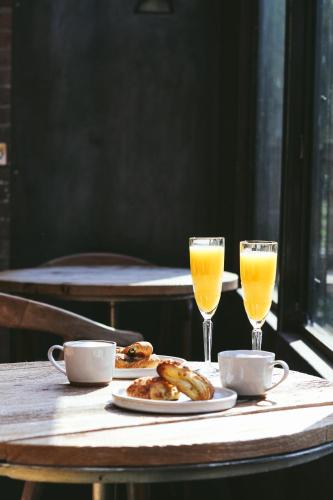 a table with two glasses of orange juice and food at Finn Lough in Pettigoe