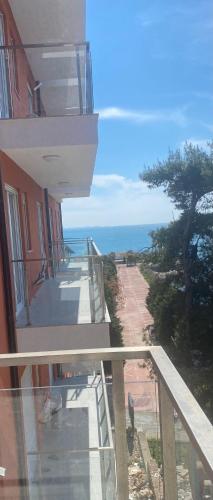a balcony of a building with a view of the ocean at Shtepipushimi23 Rana e Hedhun in Shëngjin