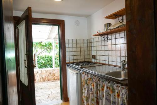 a kitchen with a sink and a stove at Dal Canonico in Mola di Bari