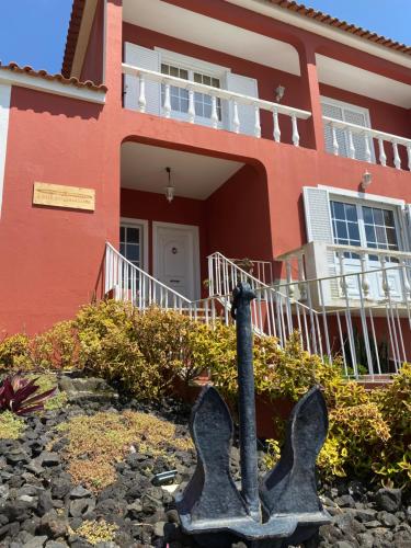 a house with a statue in front of it at A Casa do Comandante in Lagoa