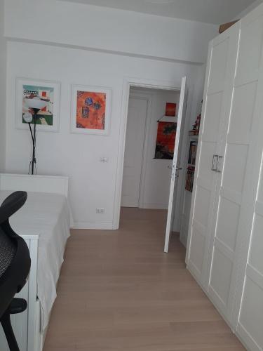 a room with white walls and a desk and a chair at Room for rent in Roma Conca d'oro near subway line b in Rome