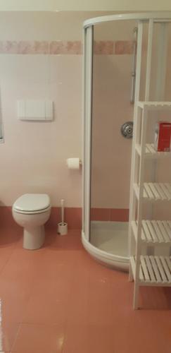 a bathroom with a toilet and a glass shower at Easy Gardalake in Riva del Garda