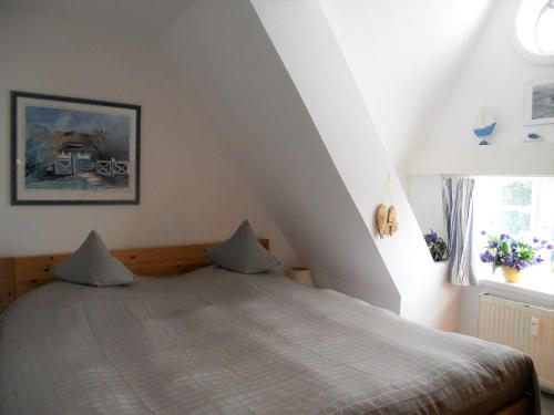um quarto com uma cama num sótão em Ole in Borgsum em Borgsum