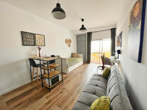 a living room with a couch and a desk at ROOM 335 in São Martinho do Porto
