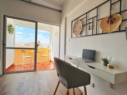 a room with a desk with a laptop on it at ROOM 335 in São Martinho do Porto