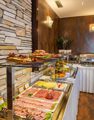 a buffet line with many different types of food at Hotel Central Beach 9 in Makarska