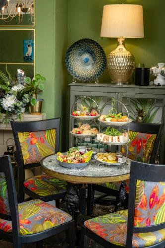 a table with plates of food on it with chairs at The Bramley House Hotel in Chatteris