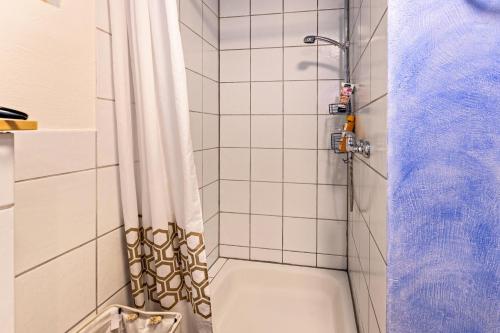 a bathroom with a shower with a shower curtain at Apartment Casa Gina in Stockach