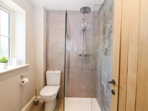 a bathroom with a toilet and a shower at Fishermans Lodge in York