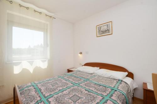 a bedroom with a large bed with a window at Miro Apartment in Rovinj