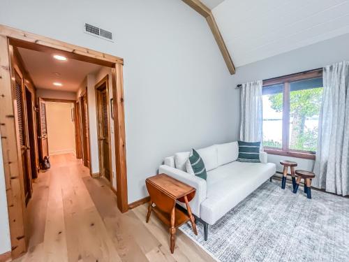 a living room with a white couch and a table at New Construction Beautiful Lake Front and Beautiful Home in Oakland