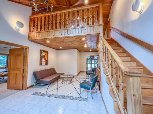 a living room with a staircase and a couch at New Construction Beautiful Lake Front and Beautiful Home in Oakland
