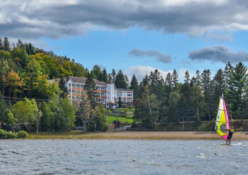 a person on a sail board in the water at Auberge Hotel Spa Watel in Sainte-Agathe-des-Monts