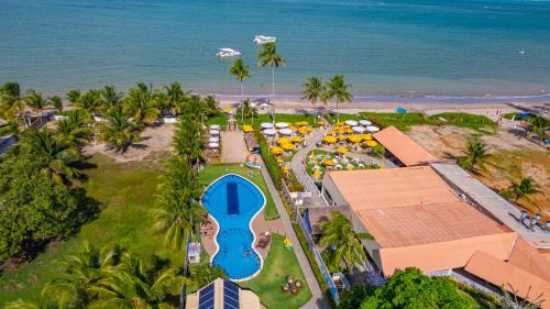 an aerial view of a resort with a pool and the beach at Pousada Polymar in Maragogi