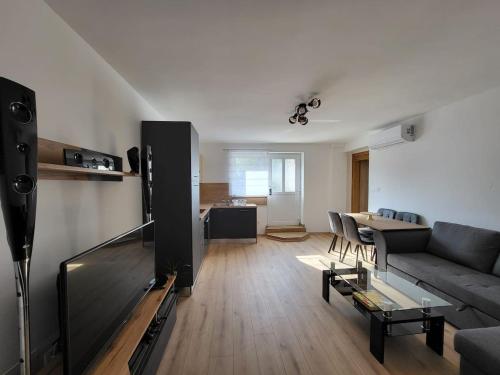 a living room with a couch and a table at Apartment Dado in Slunj