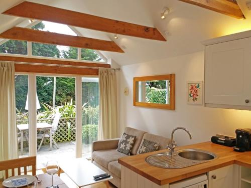 a kitchen and living room with a couch and a table at Luxury detached annexe in Kingsbridge with estuary walk to great pub & parking in Kingsbridge