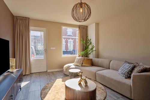 a living room with a couch and a tv at Het Oude Stadhuis in Enschede