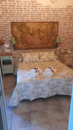 a bedroom with a bed with two towels on it at La Posada del Canario in Cangas de Onís