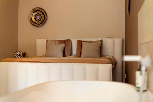 a bedroom with a bed and a clock on the wall at Het Oude Stadhuis in Enschede