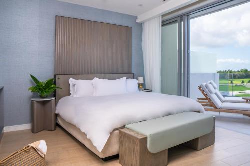 a bedroom with a large bed and a chair at Goldwynn Resort & Residences in Nassau