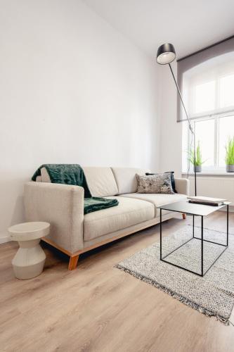 a living room with a couch and a coffee table at Apartamenty Woźna 14a, 2 rooms, self check in 24h in Poznań