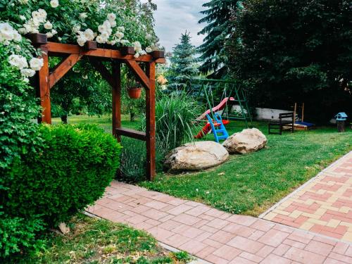 a garden with a wooden gazebo and a playground at Penzion Labská Vyhlídka in Litoměřice