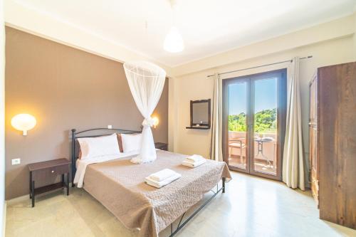 a bedroom with a bed and a balcony at Angel's Studio 4 in Agios Georgios Pagon