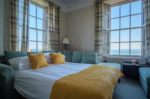 a bedroom with a large bed with yellow pillows at John McDouall Stuart View in Dysart