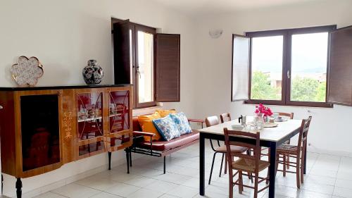 a living room with a table and a dining room at Villa To' - Arbatax, Porto Frailis in Àrbatax