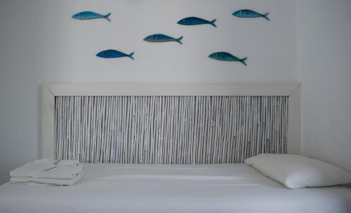 a bedroom with fish on the wall above a bed at Aeraki Studios in Kastraki Naxou