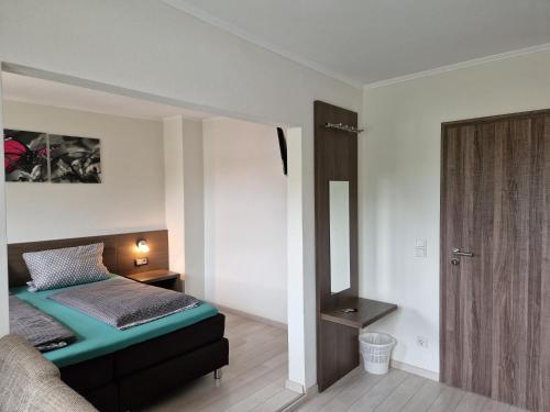 a bedroom with a bed and a mirror at LandGASTHOF Rose in Dammbach