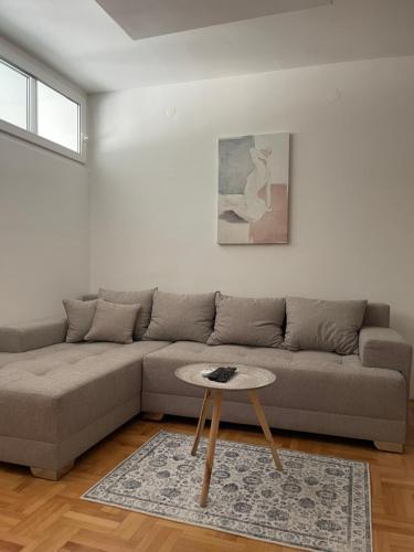 a living room with a couch and a table at Apartman Spark in Valjevo