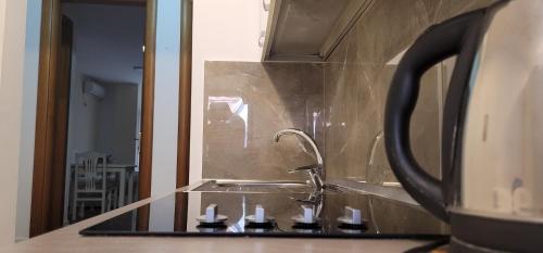 a bathroom counter with a sink and a mirror at Studenti Studio's in Tirana