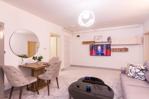 a living room with a couch and a table at Apartment FiVe Visoko in Visoko