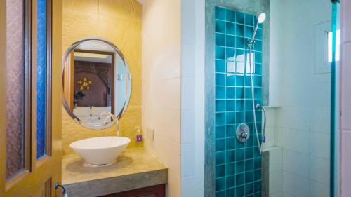 a bathroom with a sink and a mirror at Korbua House in Bangkok