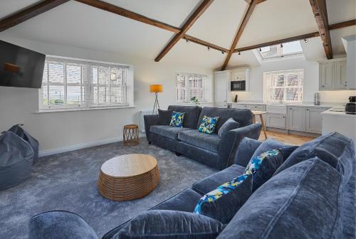 a living room with a blue couch and a table at Host & Stay - 1 The Mount in Whitby