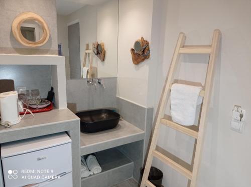 a small kitchen with a ladder in a room at Iniohos Zante Hotel & Suites in Argasi