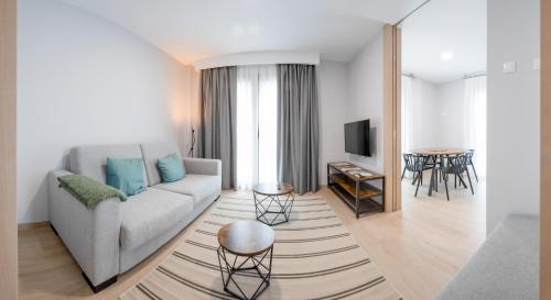 a living room with a couch and a table at Apartamentos Villa Zoila Nigrán in Nigrán