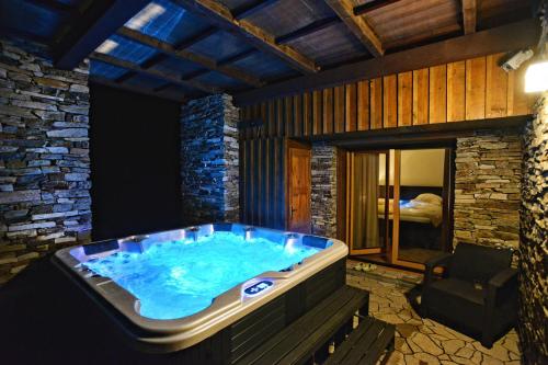 a jacuzzi tub in a room with a bedroom at Luxury Wellness Apartment in Rokytnice nad Jizerou