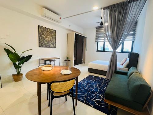 a living room with a table and a couch at Chambers Serviced Suites KLCC by Cozy Stay in Kuala Lumpur