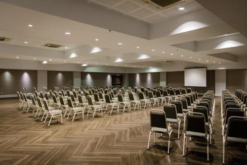 a large room with rows of chairs and a screen at Promenade Link Stay Barra da Tijuca in Rio de Janeiro