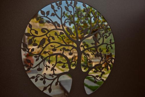 a picture of a tree in a window at "La Casa dei Gelsi" - Panorama Lodge MONTE GENEROSO in Scudellate