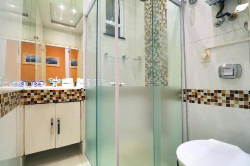 a bathroom with a shower with a toilet and a sink at Rio Spot Homes C046. in Rio de Janeiro