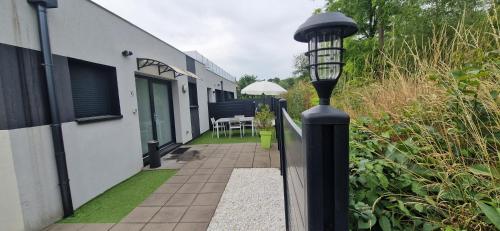 a black light pole next to a building with a patio at Au petit canal de COLMAR 2 in Kunheim