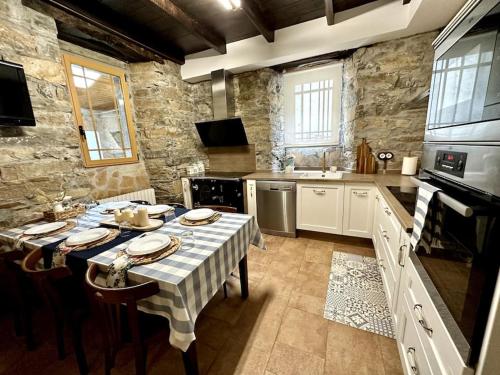 a large kitchen with a table with plates on it at Casa Arturo in Tríacastela
